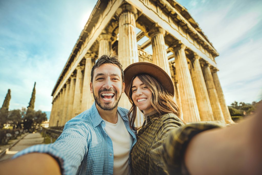 Happy couple in love visiting the Acropolis of Athens, Greece -