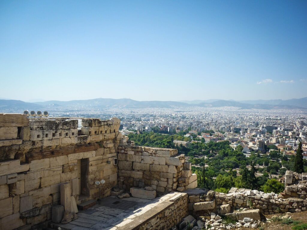 a stone building with a city in the background